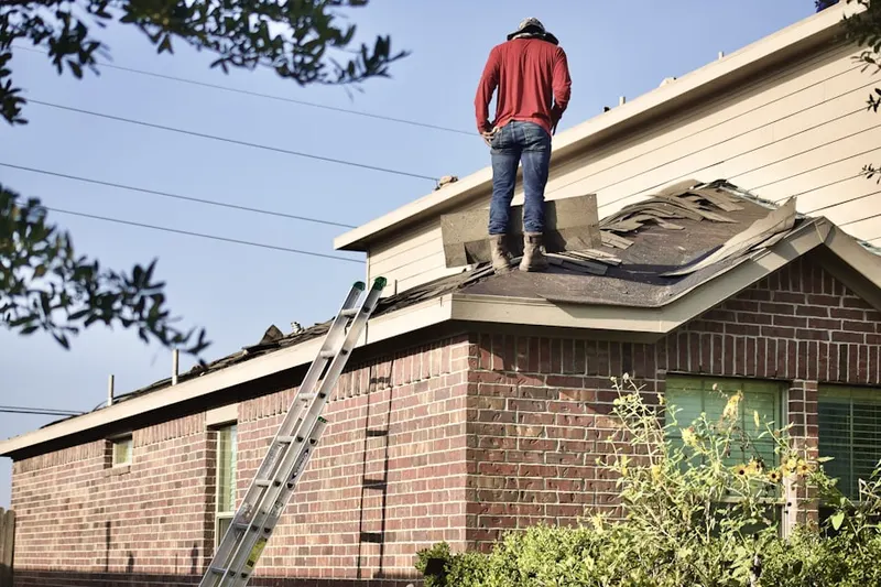 Professional roofer working on a residential roof in Lower Dutchtown